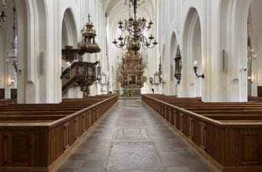 a church with pews and chandeliers