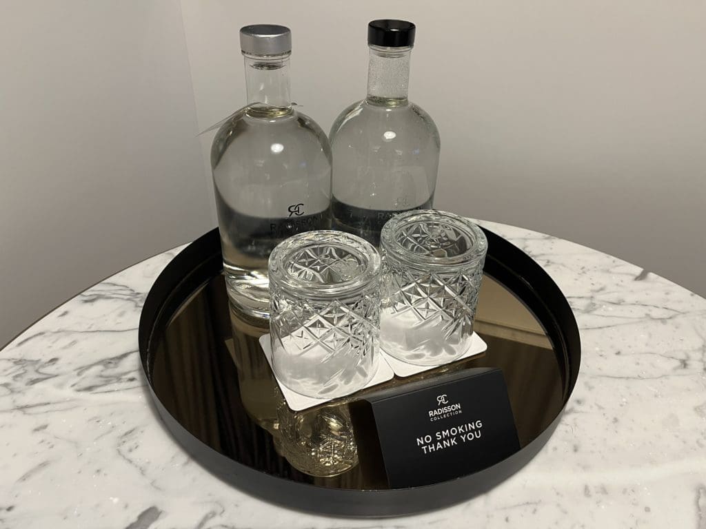 a group of bottles and glasses on a tray