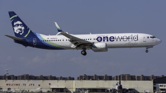 a white airplane with blue and white text on it