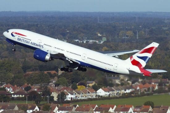 a large airplane flying over a city