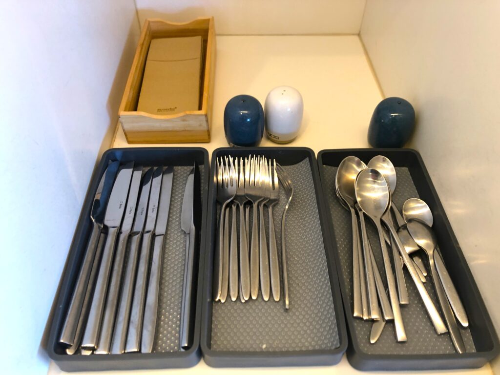 a trays of silverware and salt shakers