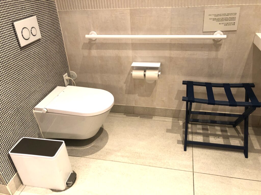 a bathroom with a toilet and a blue stool
