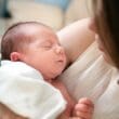 a woman holding a baby