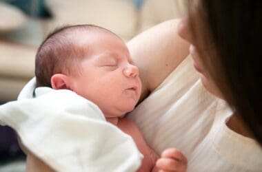 a woman holding a baby