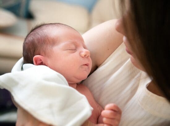 a woman holding a baby