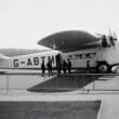 a group of people standing next to an airplane