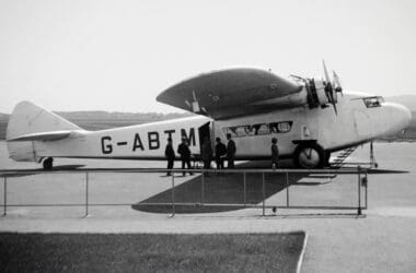 a group of people standing next to an airplane