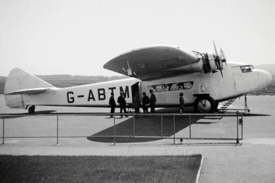 a group of people standing next to an airplane