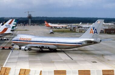 a large silver airplane on a runway