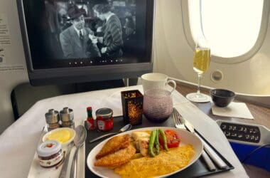 a plate of food on a table with a television