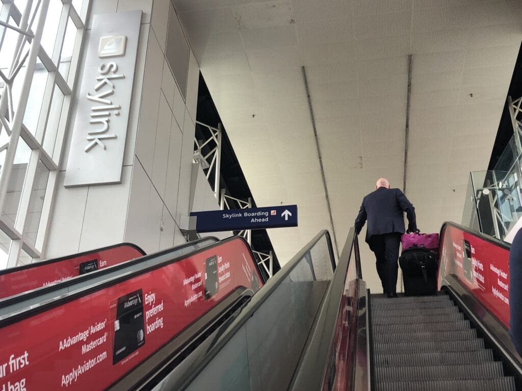 a man walking up an escalator