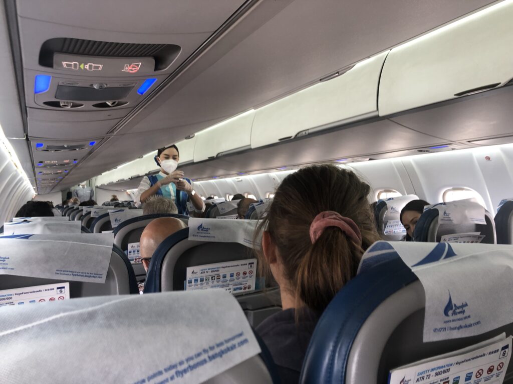 a person wearing a mask on a plane