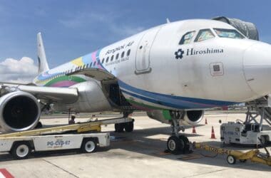 a large airplane with a colorful stripe on it