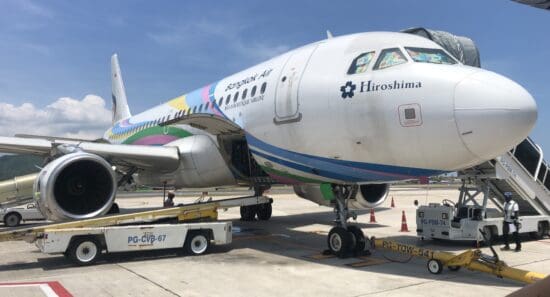 a large airplane with a colorful stripe on it