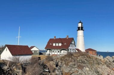 a lighthouse on a rocky hill