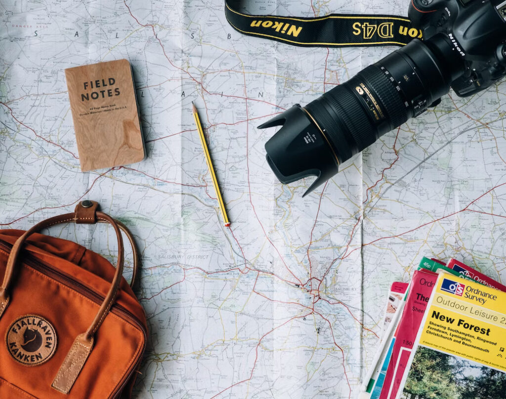 a camera and a backpack on a map