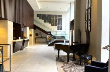 a lobby with a piano and a staircase