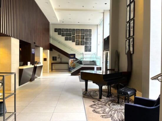 a lobby with a piano and a staircase