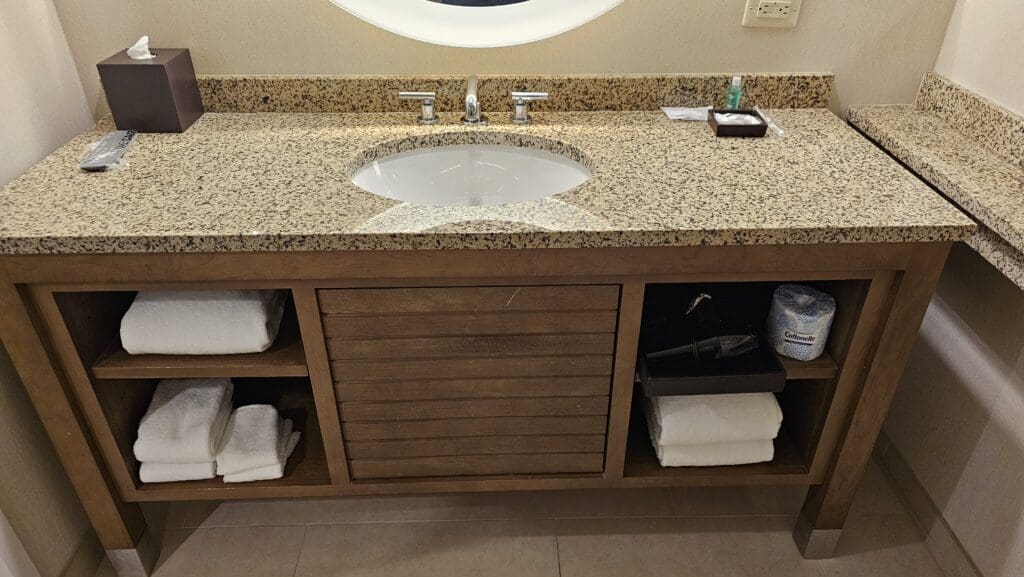 a bathroom sink with a mirror and towels