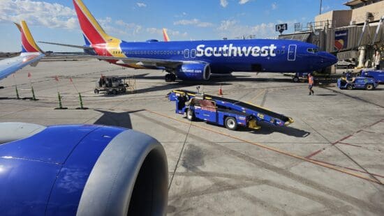 a blue airplane with a blue trailer on the ground