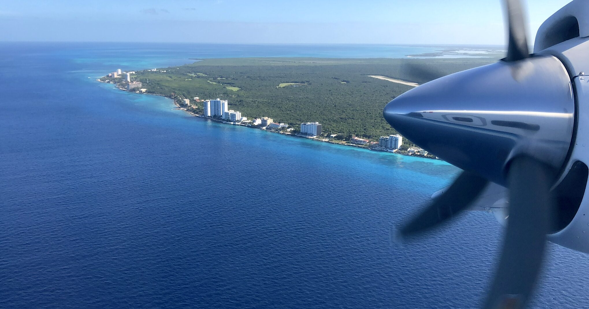 an airplane wing over a body of water