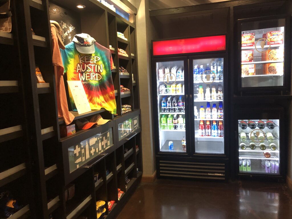 a display case with drinks and a shirt on it