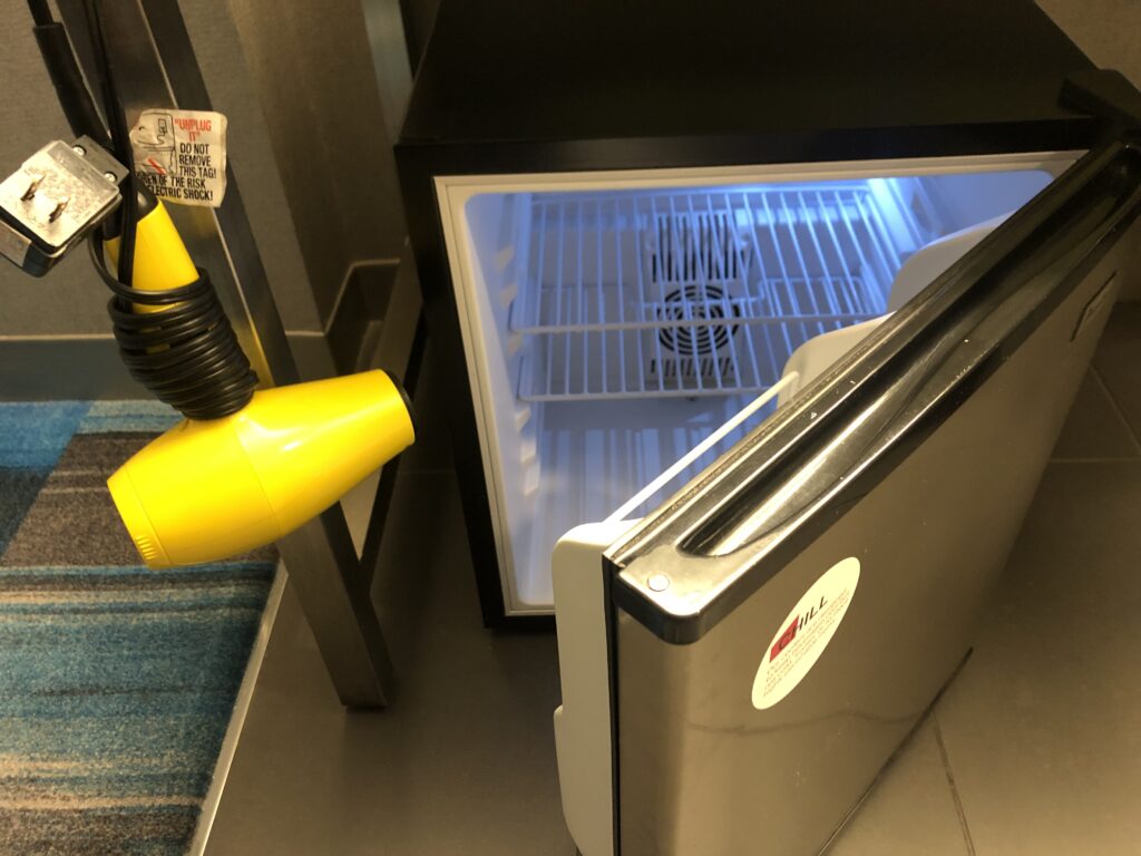 a small refrigerator with a blow dryer