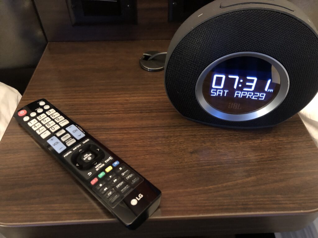 a remote control and alarm clock on a table