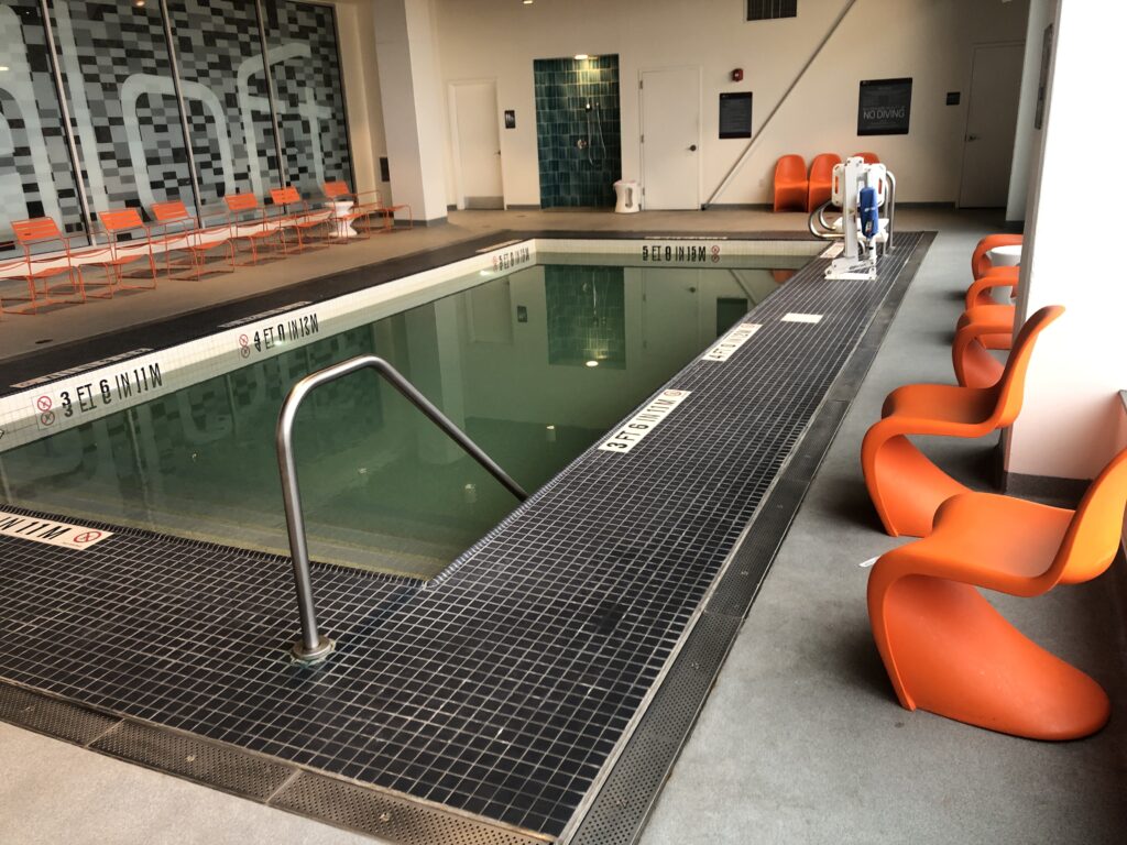a pool with orange chairs