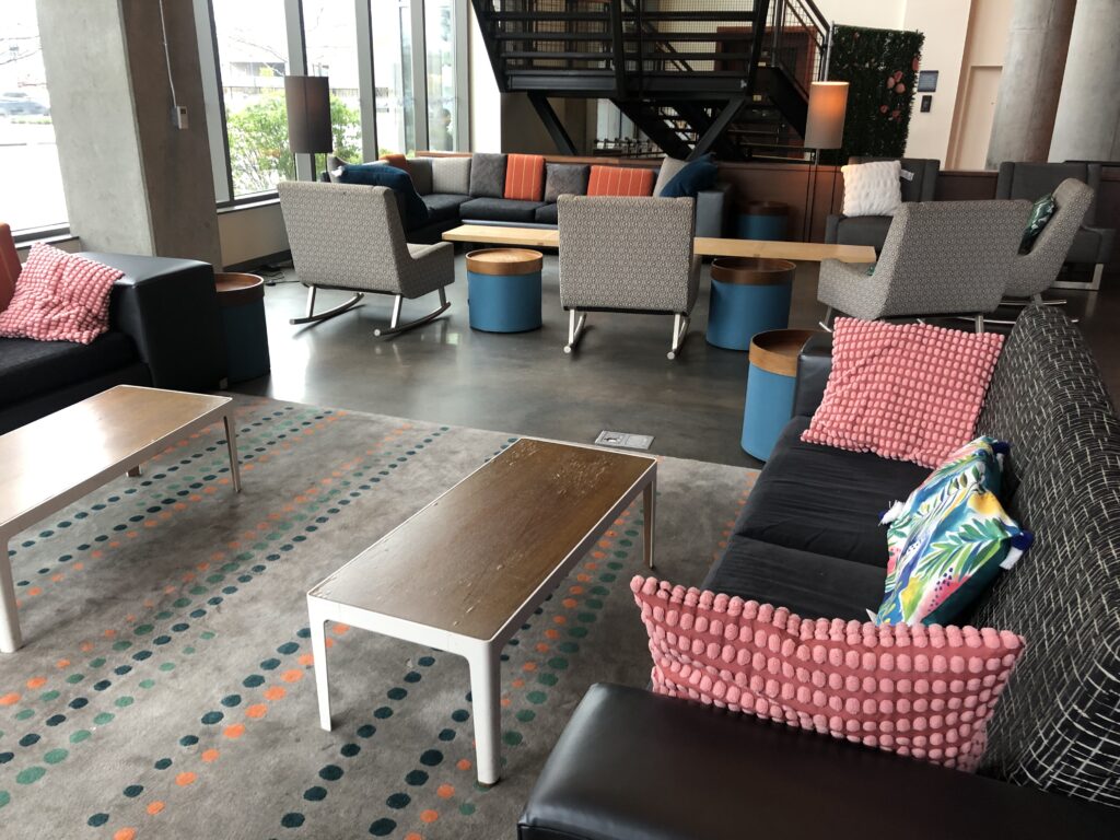 a room with a couch and chairs