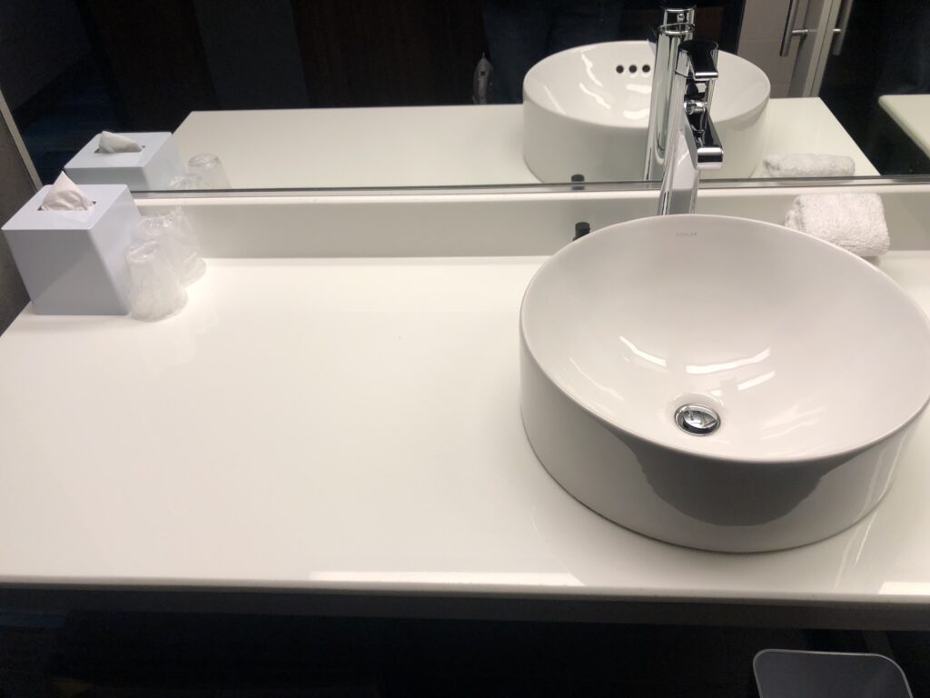a white sink and mirror