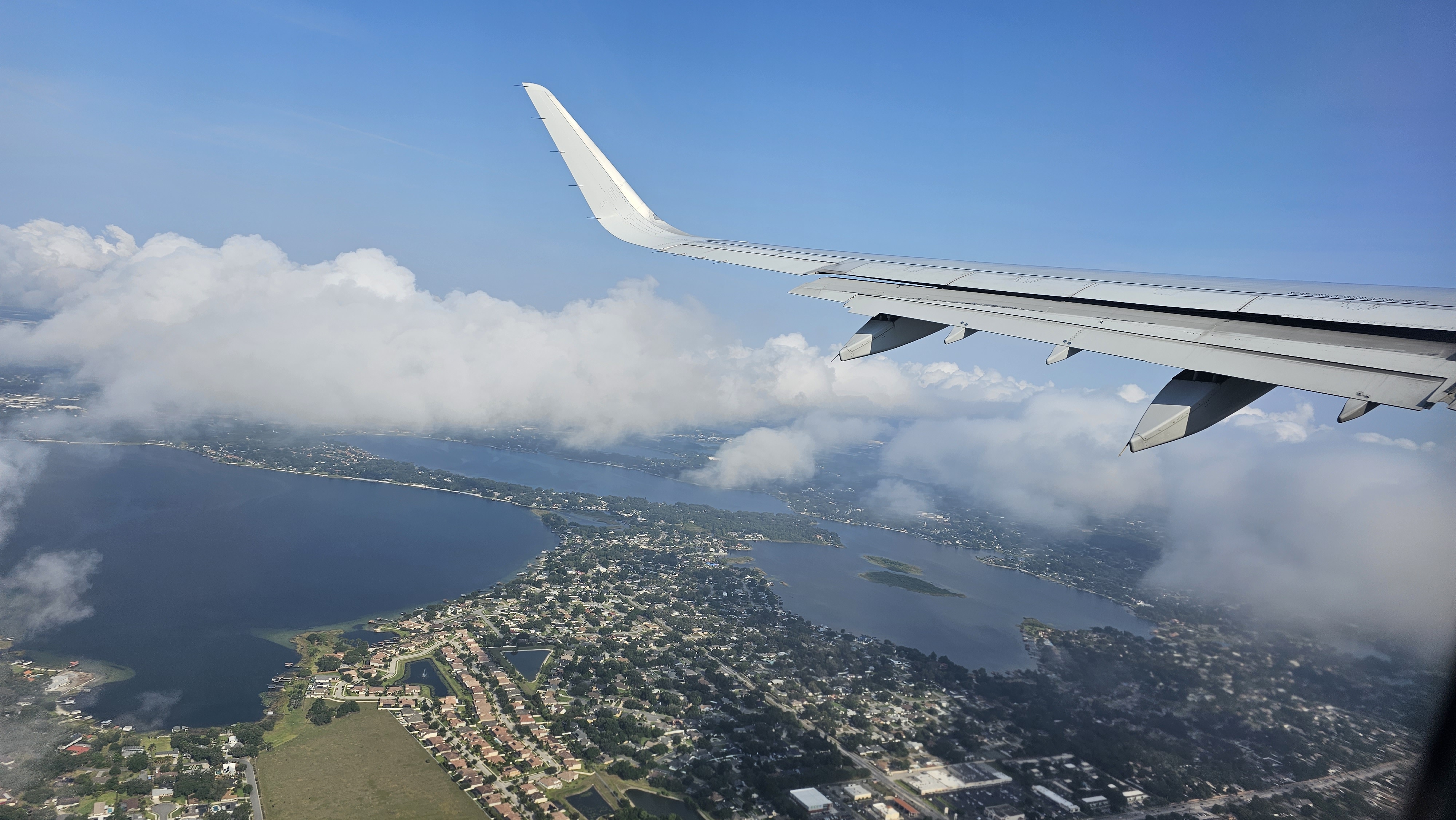 an airplane wing above a body of water