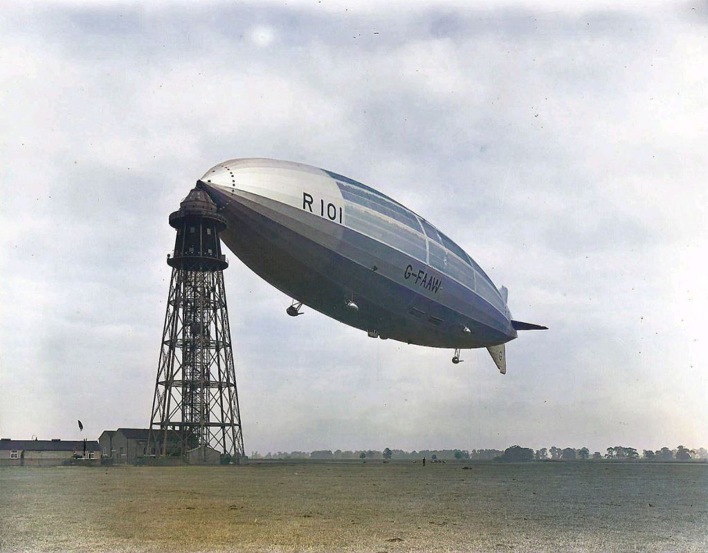 a blimp flying over a tower