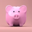 a pink piggy bank with black eyes