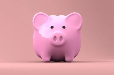 a pink piggy bank with black eyes