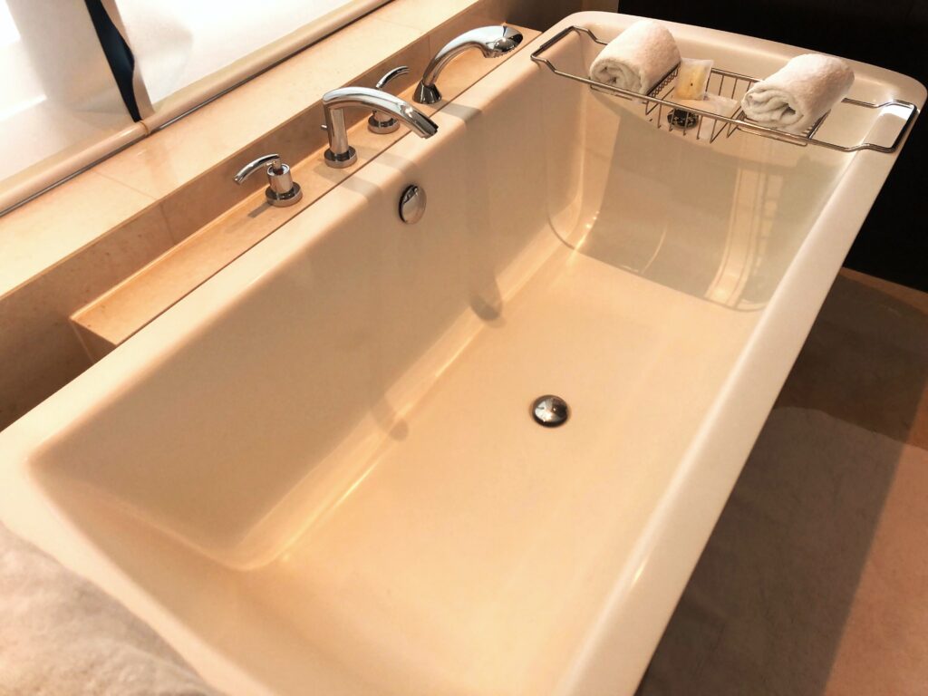 a sink with faucets and a towel rack