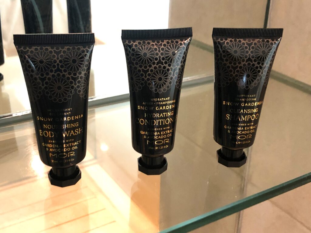 a group of black containers with gold text on them