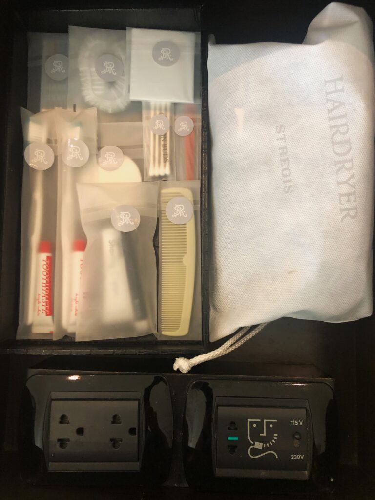 a small box with a small bag and a small toothbrush