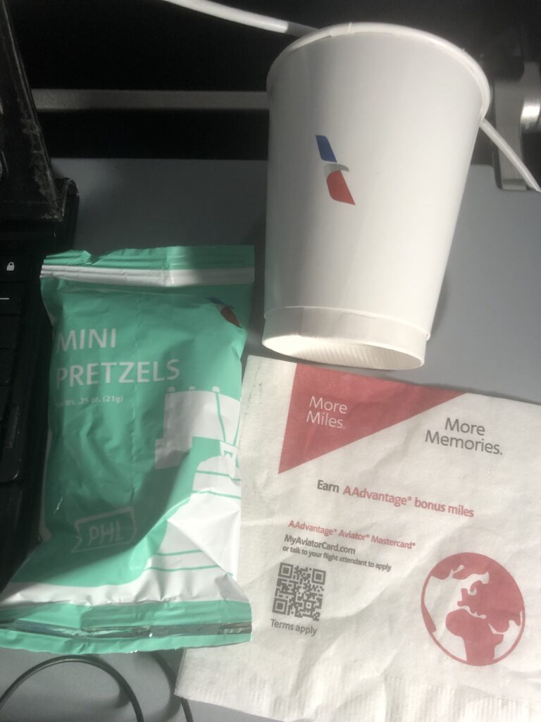 a white cup and a bag of chips