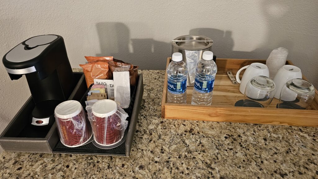 a tray of coffee and water bottles on a counter