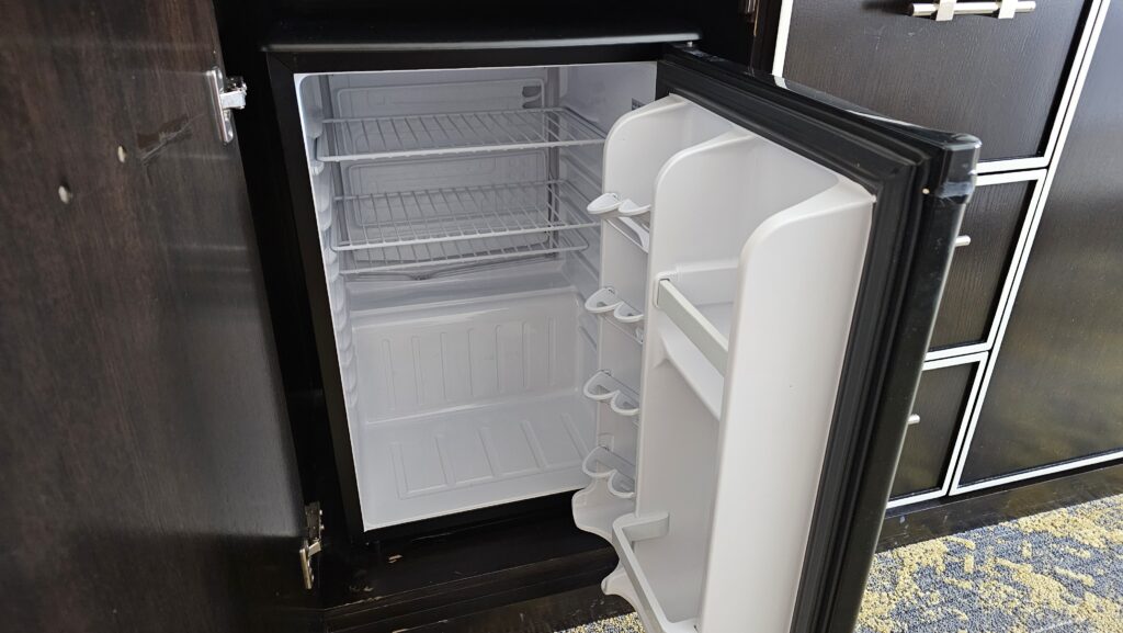 a small refrigerator with shelves
