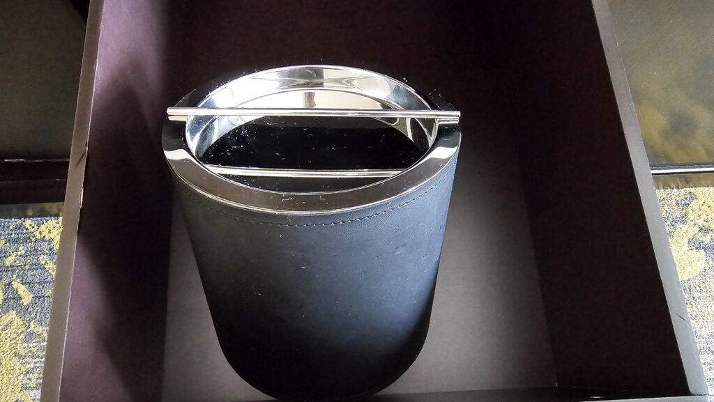 a black container with a silver handle