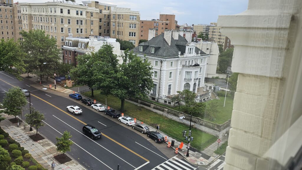 a view of a street with cars and buildings