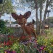 a statue of a deer in a garden