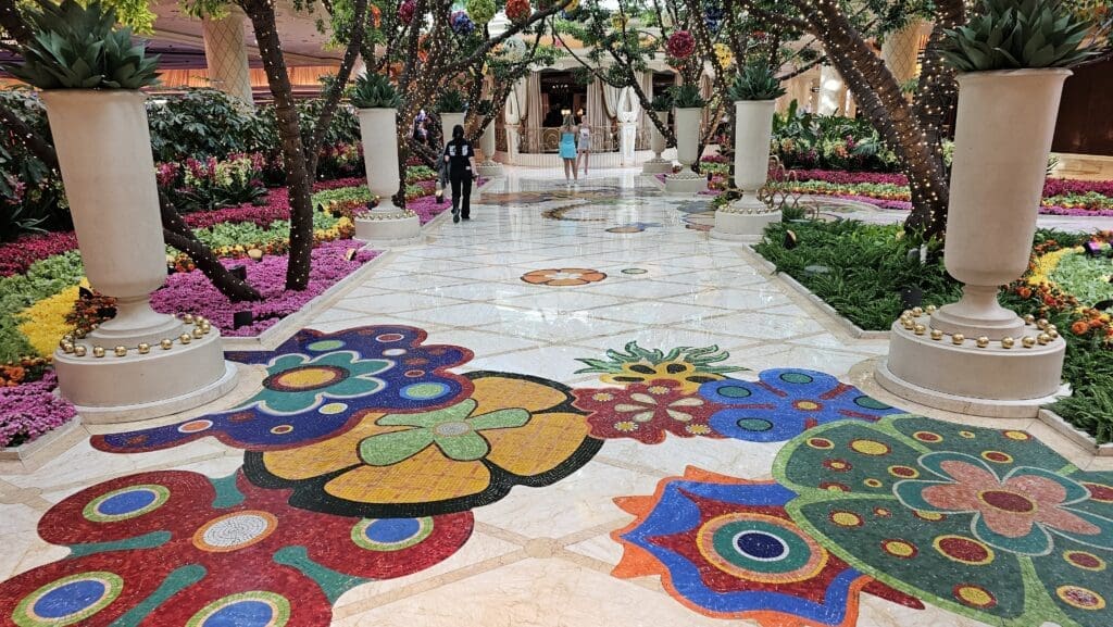 a colorful mosaic floor with trees and people walking