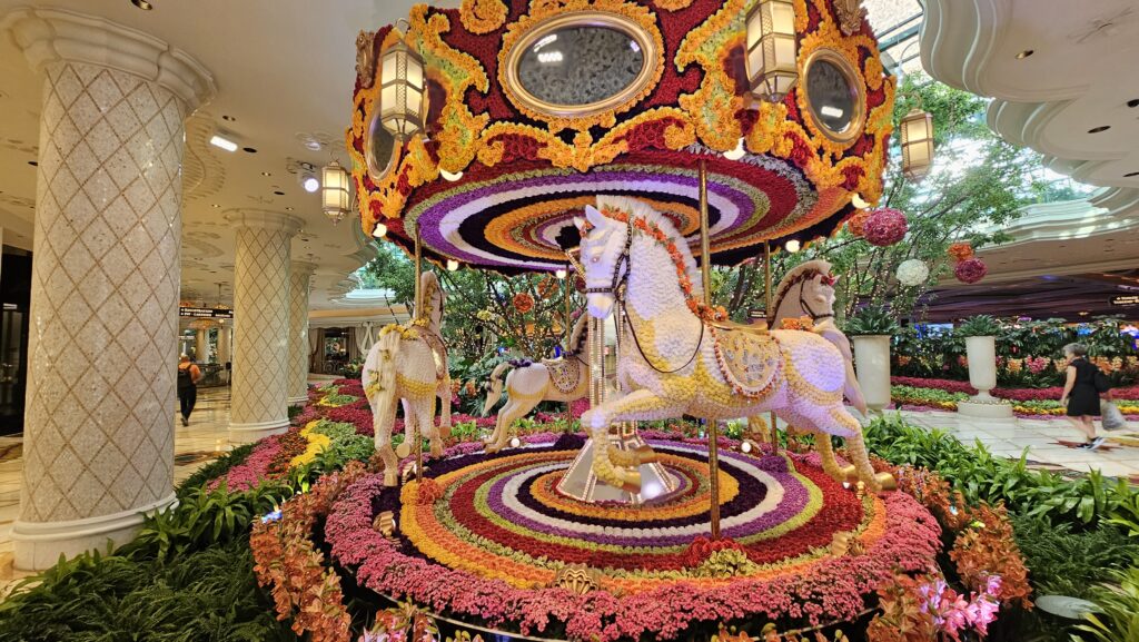a carousel with horses and flowers