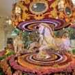 a carousel with horses and flowers