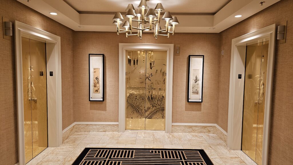 a hallway with a door and a chandelier