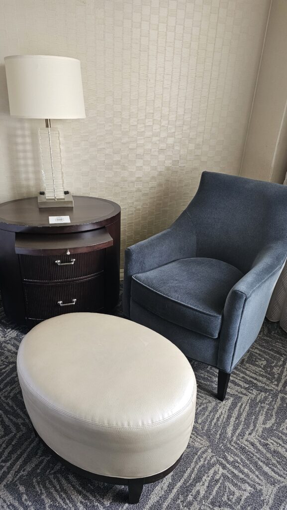 a chair and a round table in a room