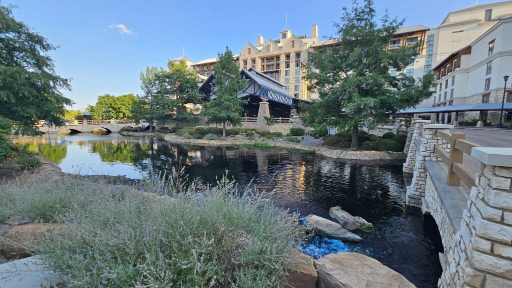 a building with trees and a body of water